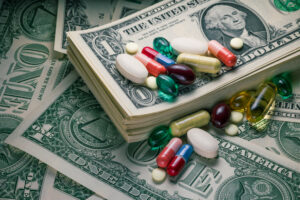 close-up studio macro shot of various pills on US dollar bills.